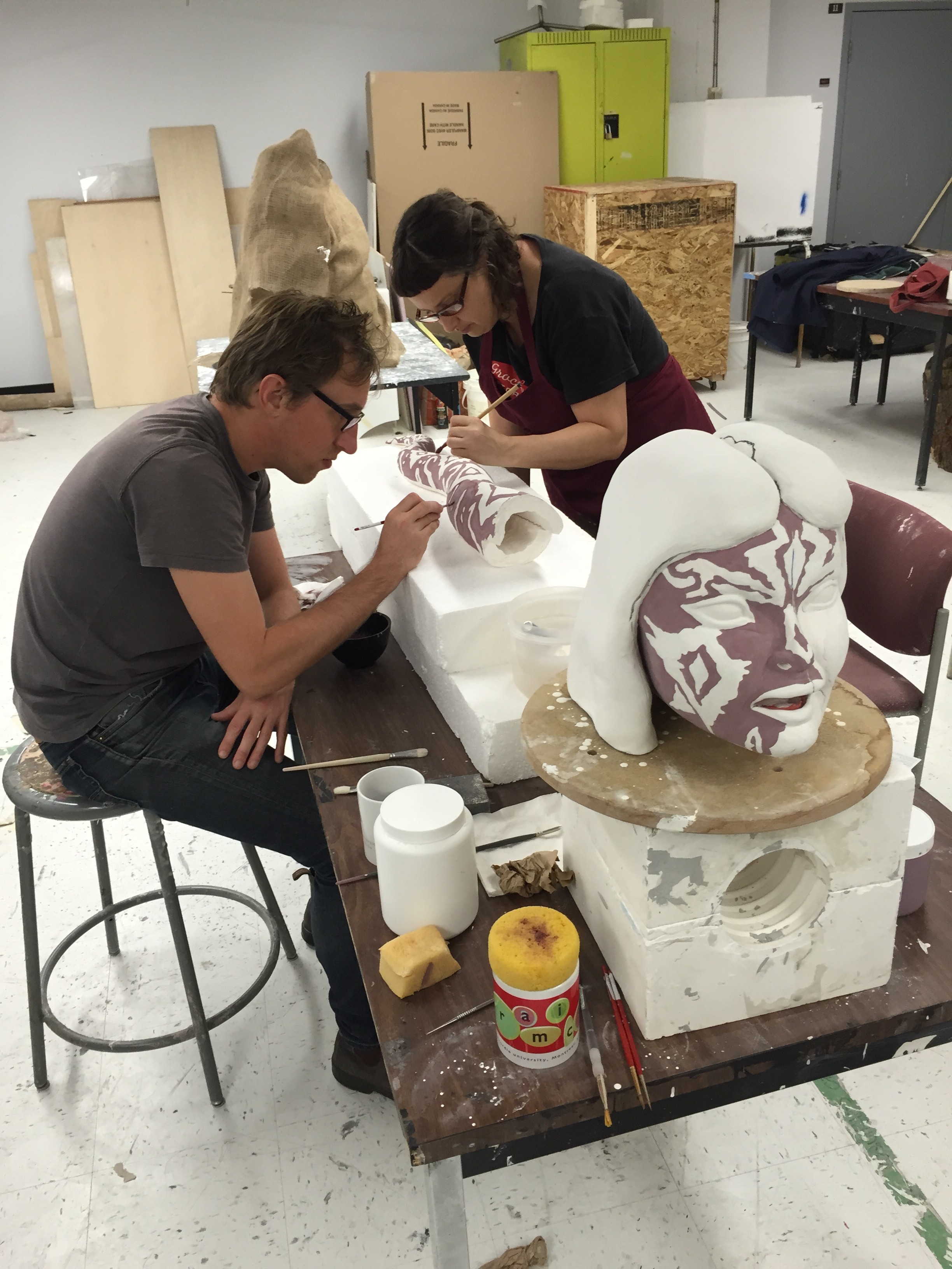 Steve and Susan painstakingly paint transparent and mirror glaze on bisqued sculpture